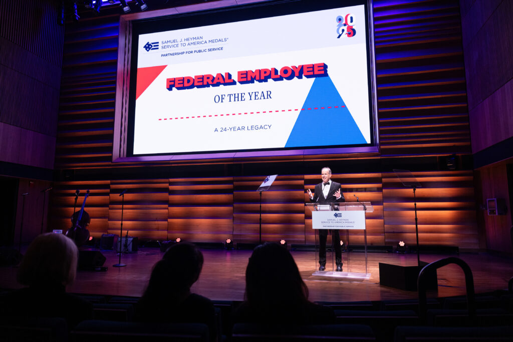 Photo of David Lebryk, the 2025 Samuel J. Heyman Service to America Medals Federal Employee, sharing his acceptance speech at a podium